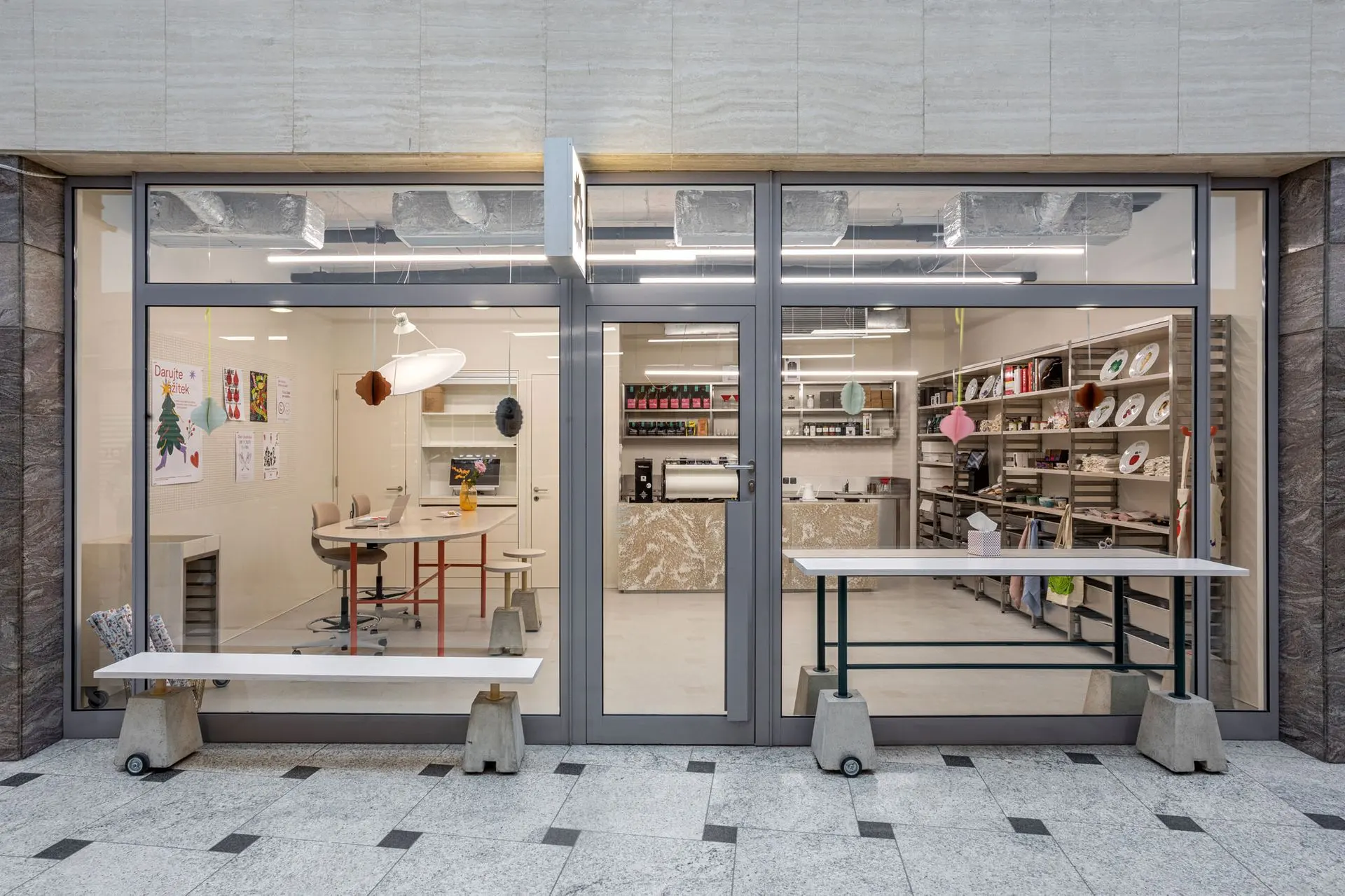 Storefront of Klub Ambiente with a modern interior and retail shelves.