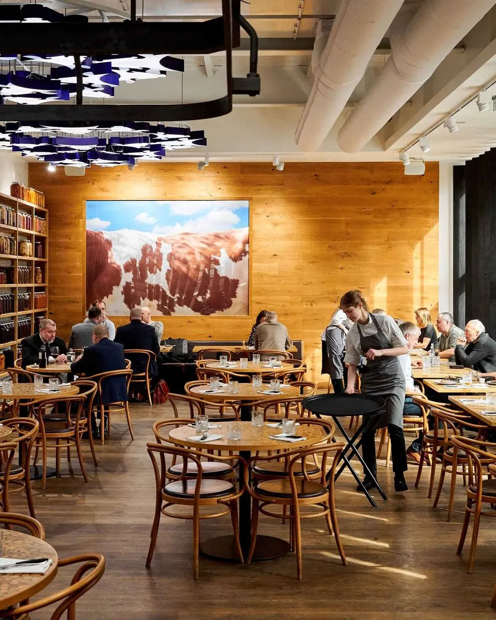 Interior of Čestr restaurant with wooden furniture and an open dining space.