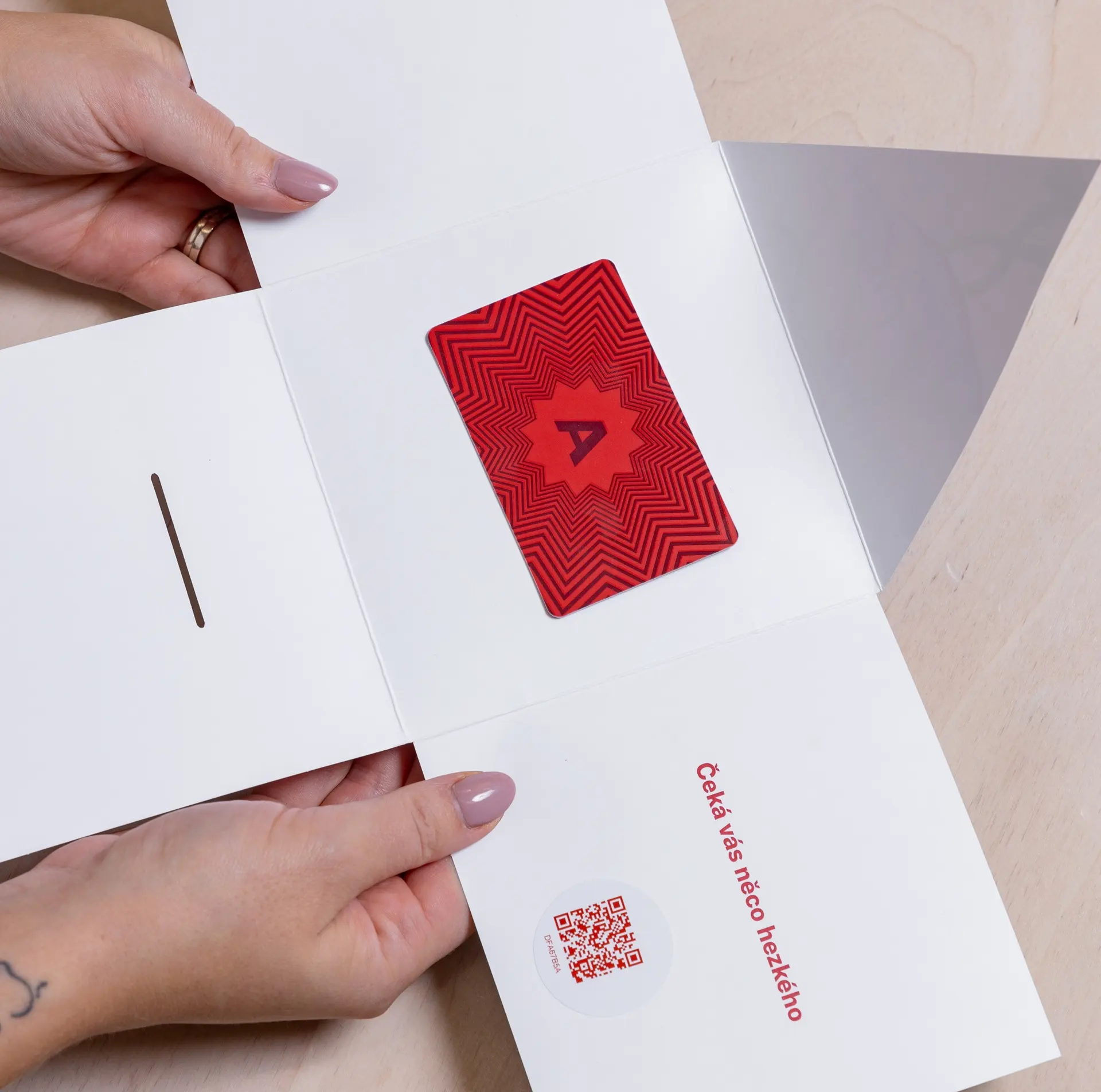 Ambiente gift card in an open greeting card with a QR code.